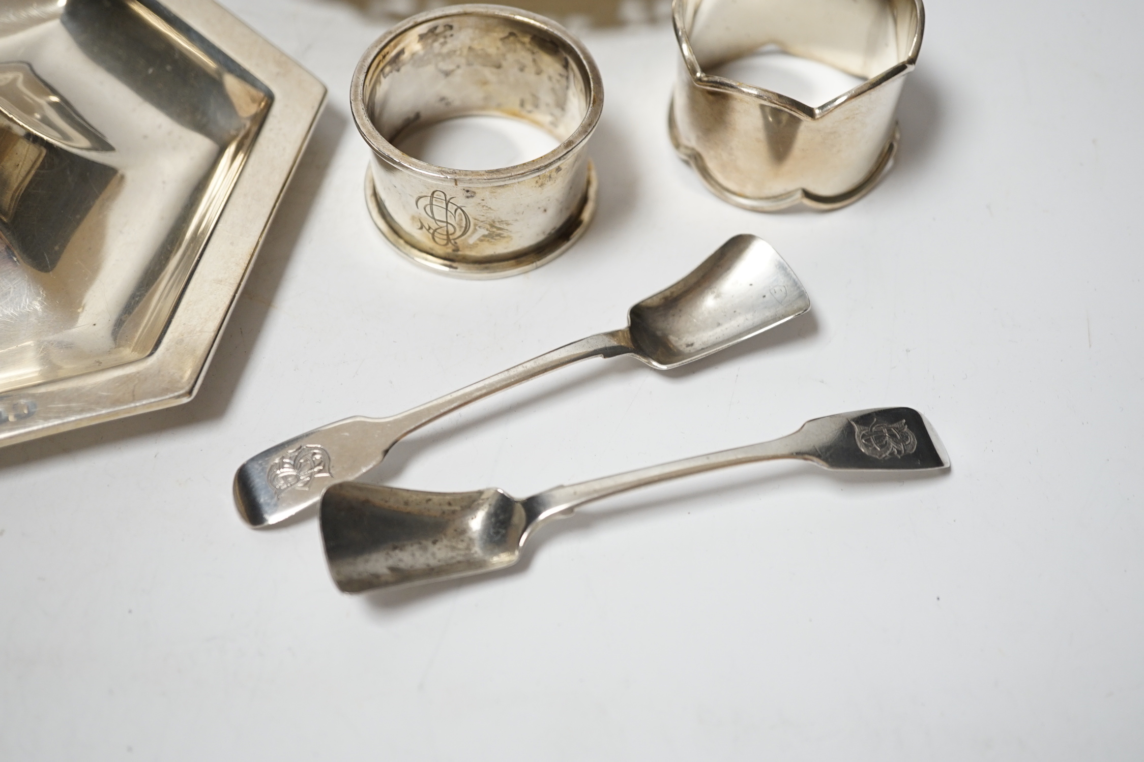 A Dutch white metal ashtray, with pierced border, 13.1cm and one other silver hexagonal ashtray?, a pair of small silver toastracks, two silver napkin rings and six items of silver flatware, including pair of Irish condi